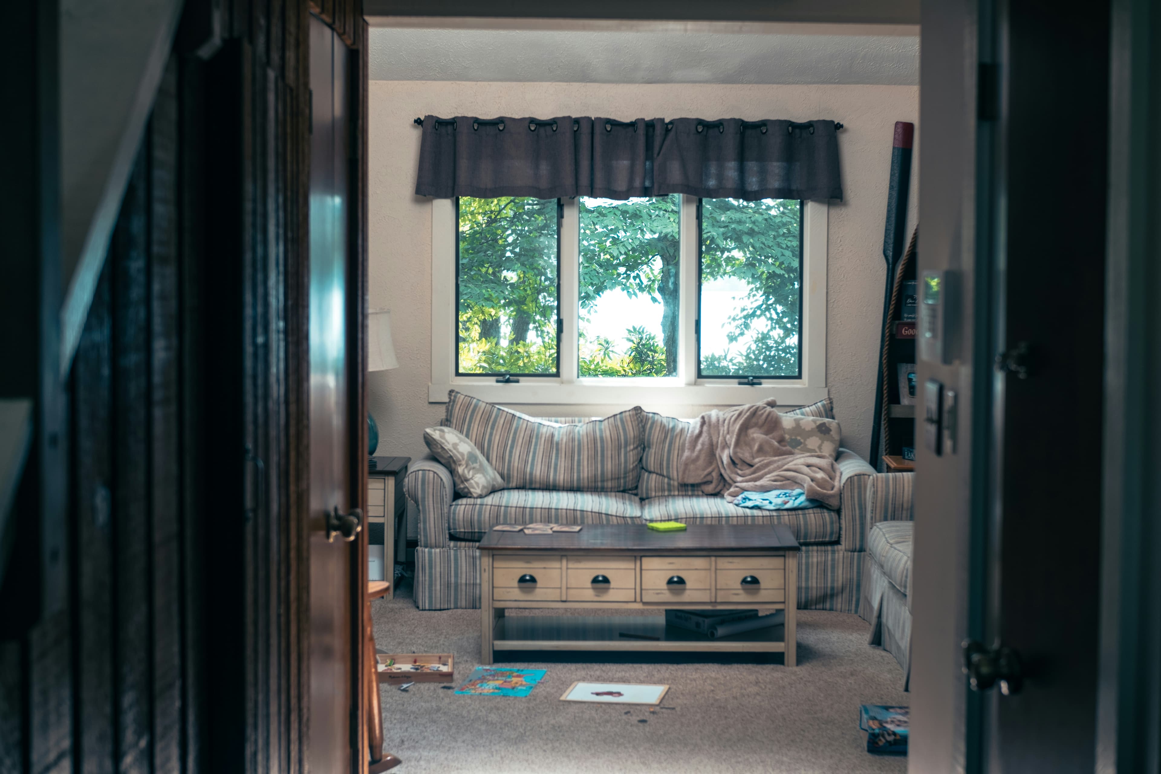 A lived-in living room with everyday belongings left in place